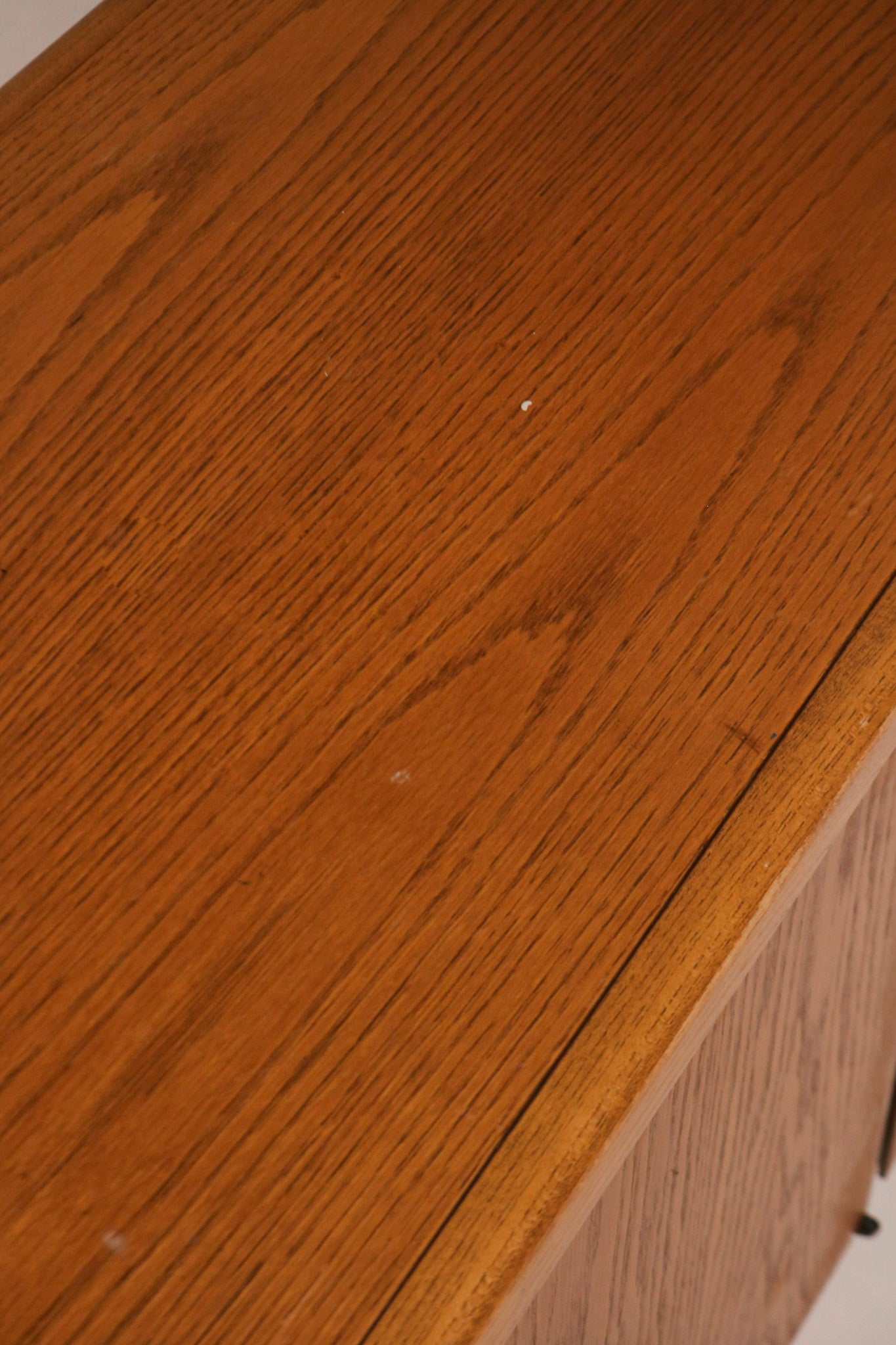 Close-up of the oak wood grain texture on the credenza surface