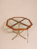 High angle view of octagonal glass table with wood frame and metal base