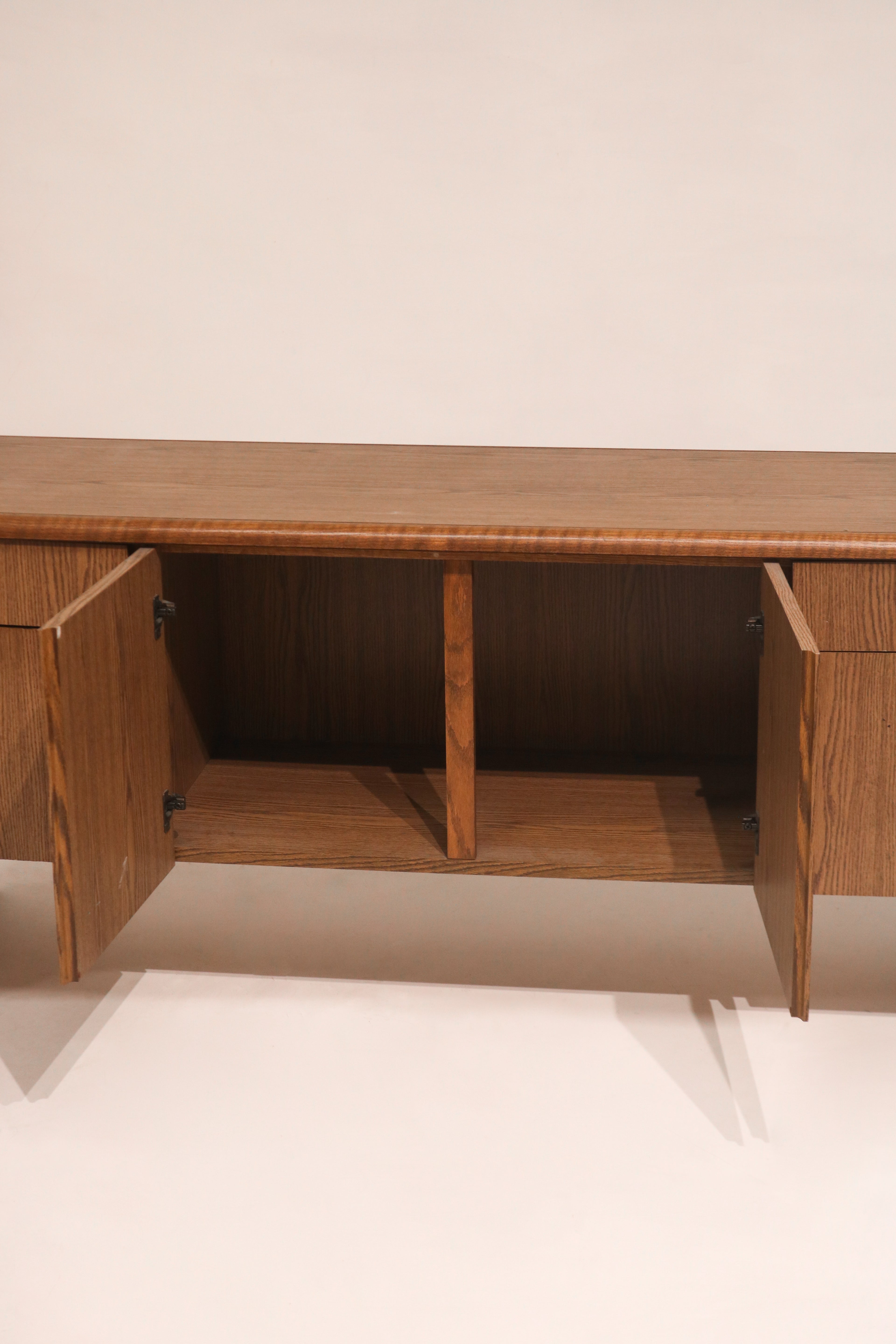 View of open cabinet doors revealing interior shelving and storage space