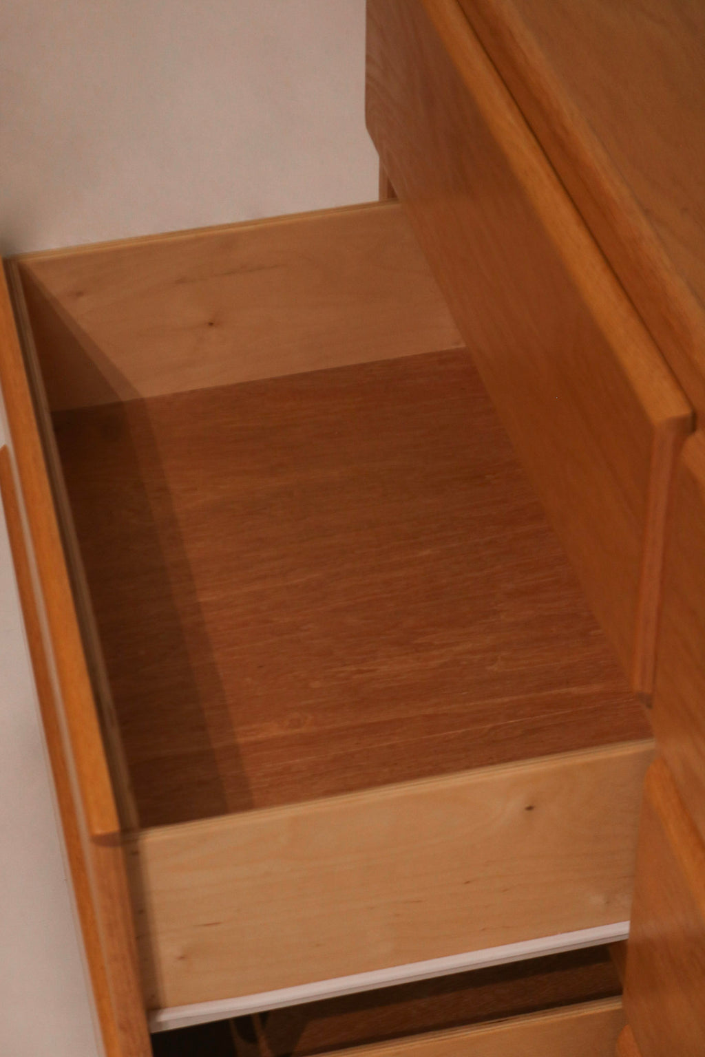 Open drawer view showing clean plywood interior construction