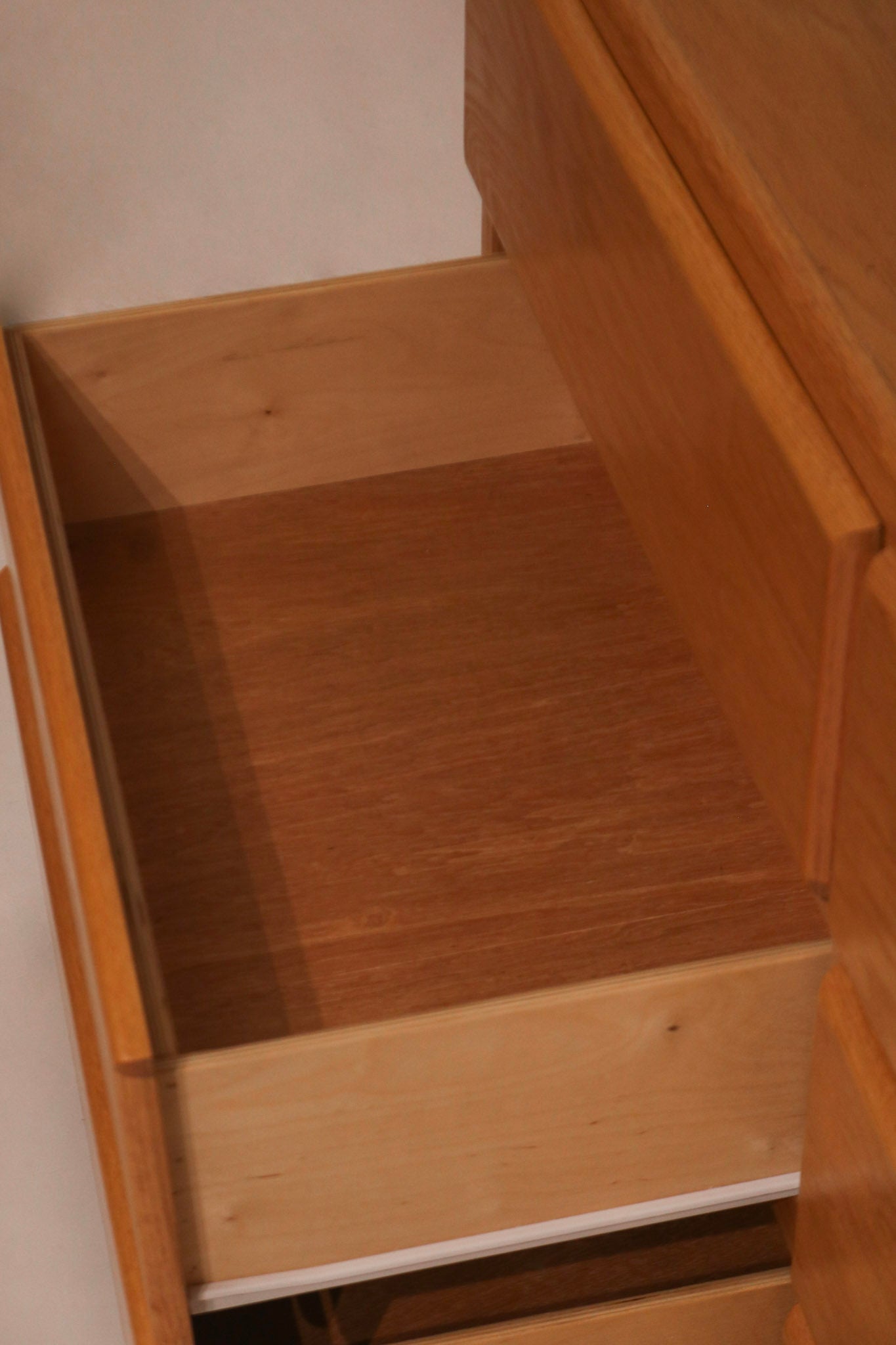 Open drawer view showing clean plywood interior construction