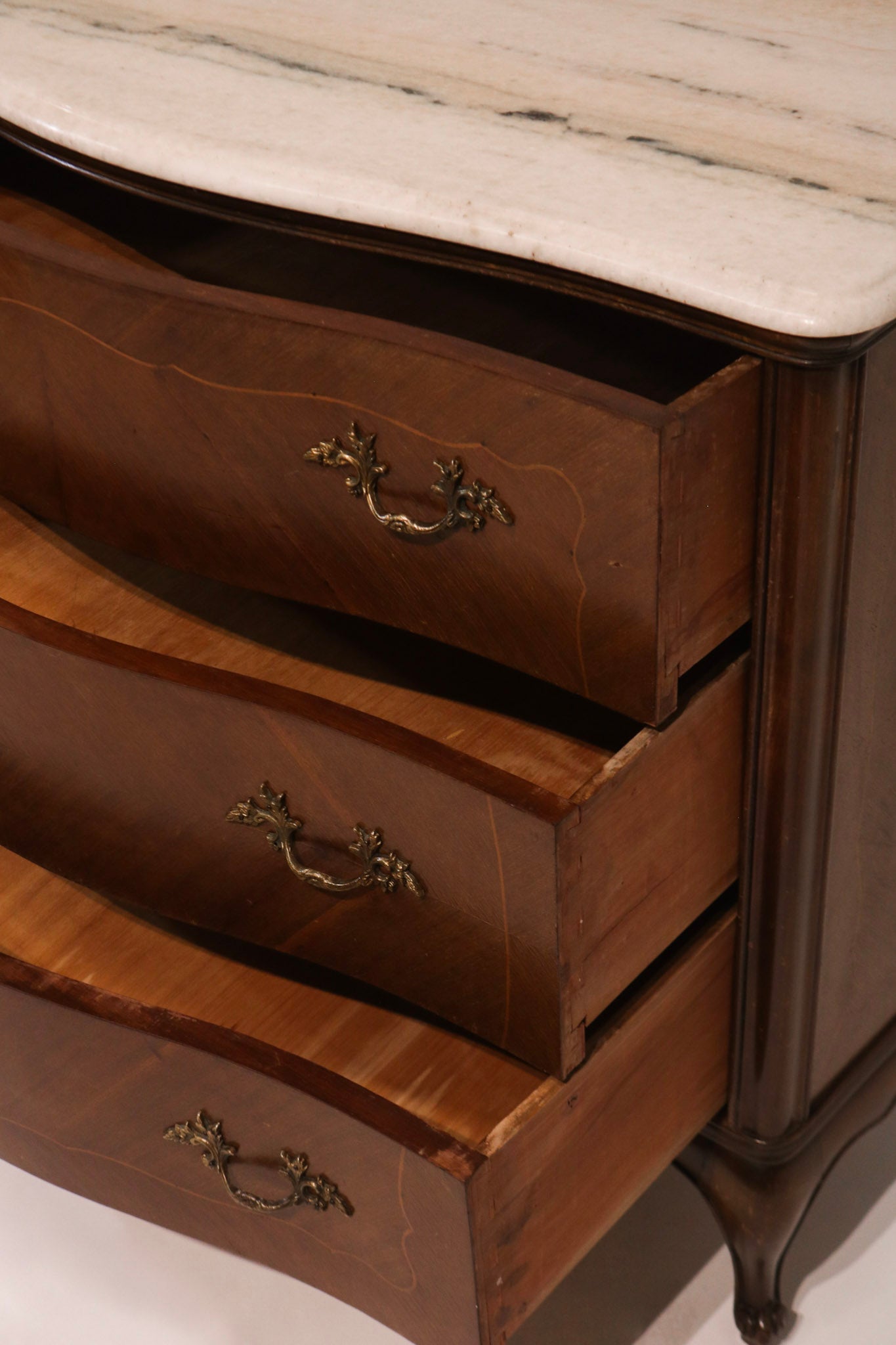 View of open drawers showing storage capacity and curved front design