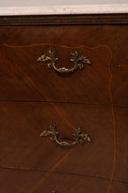 Close-up of ornate brass drawer pulls and hardware