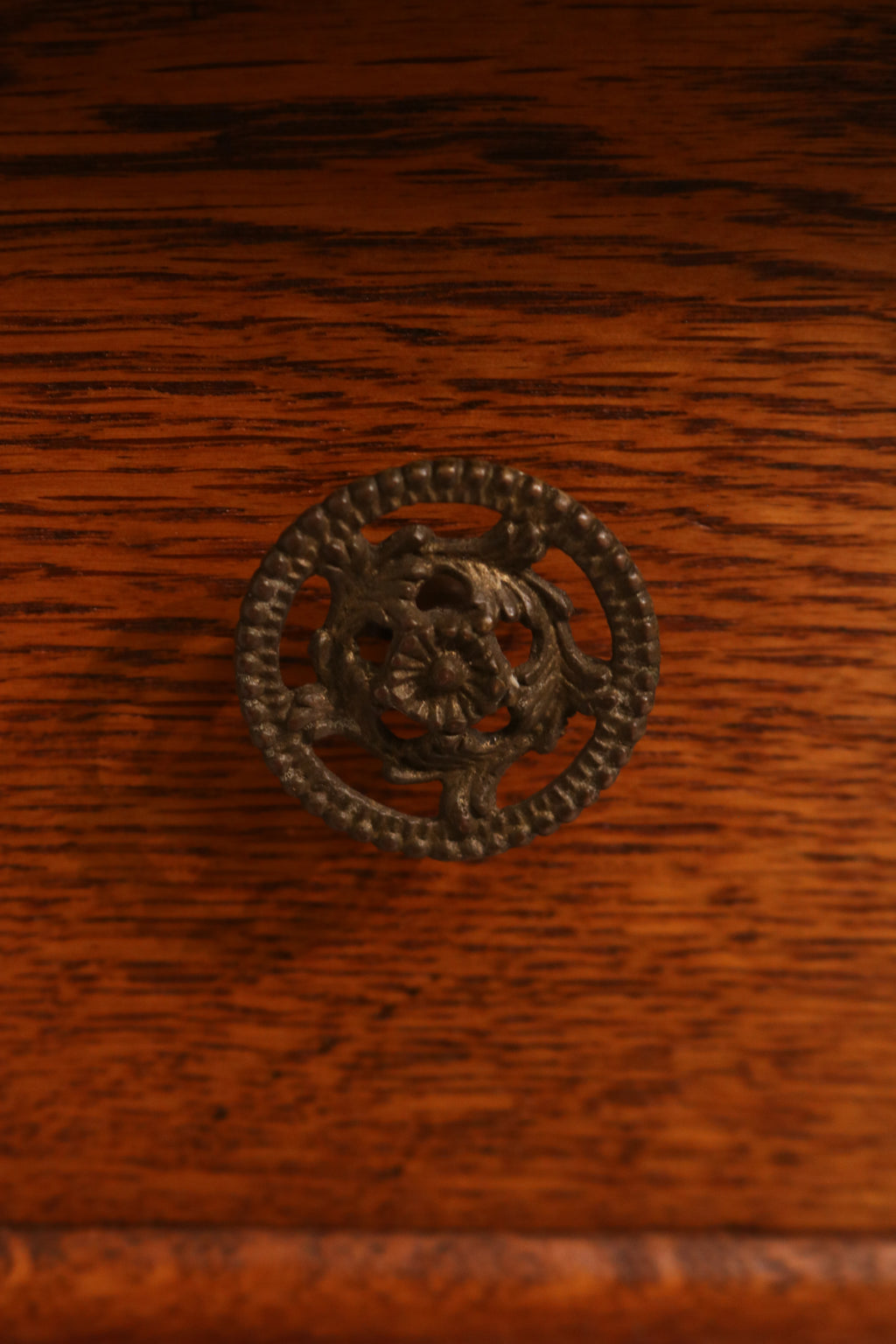 Detail of ornate metal knob on the drawer front