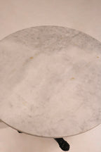 Detail of the black ornamental pedestal base supporting the top