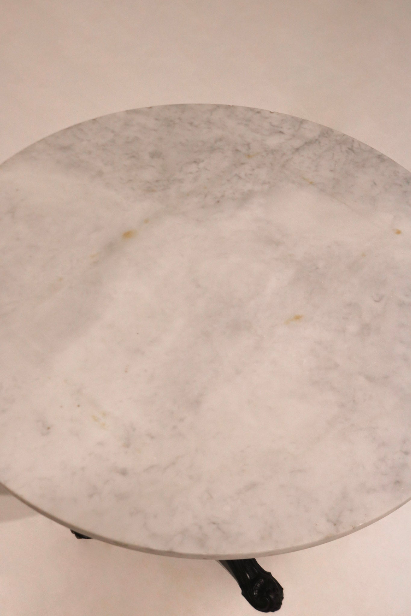 Detail of the black ornamental pedestal base supporting the top