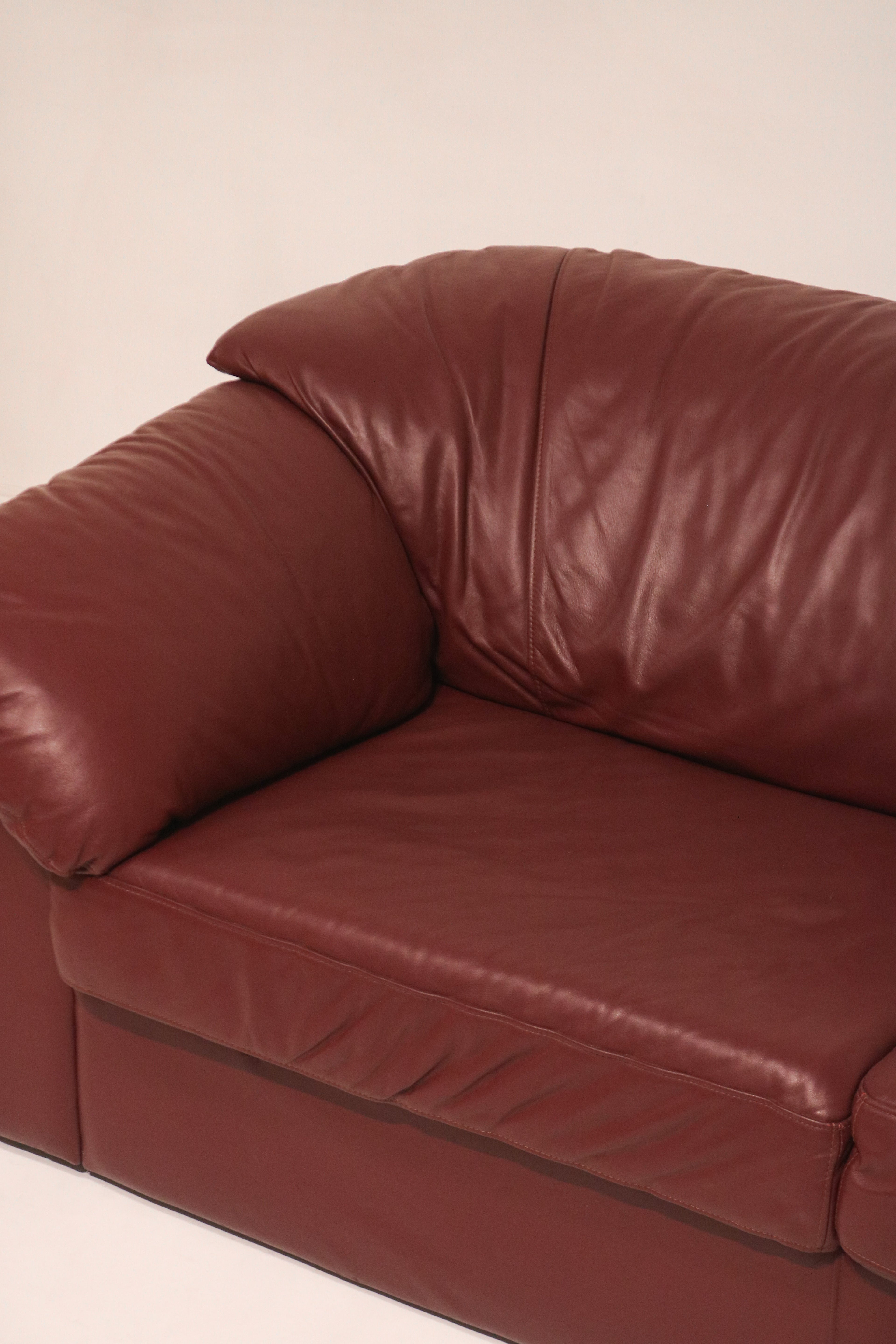 Close-up of the plush pillow-style armrest and gathered leather detail
