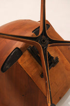 Close-up of plywood armrest edge showing vintage wear and finish condition