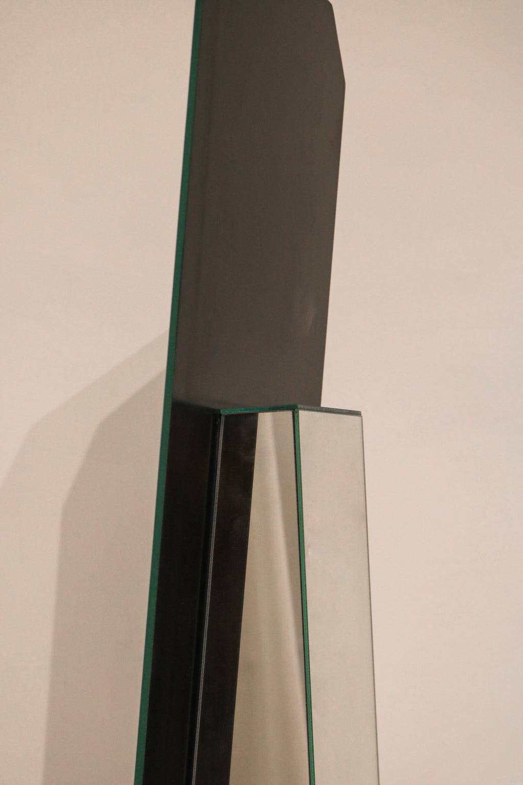 Left angle view rare standing mirror with geometric mirrored panel construction