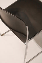 Rear angled view showing chair back design and chrome leg structure