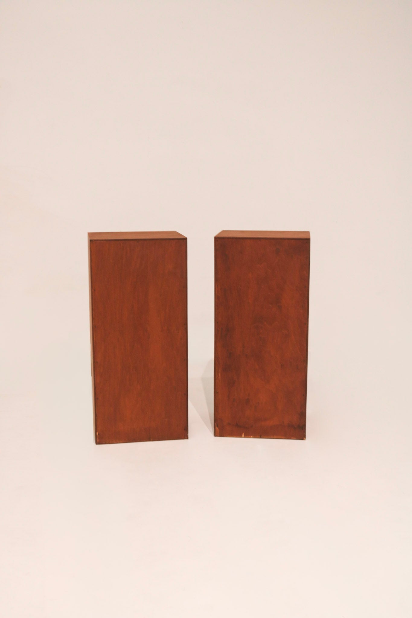 Rear view of both nightstands showing solid wood back panel construction