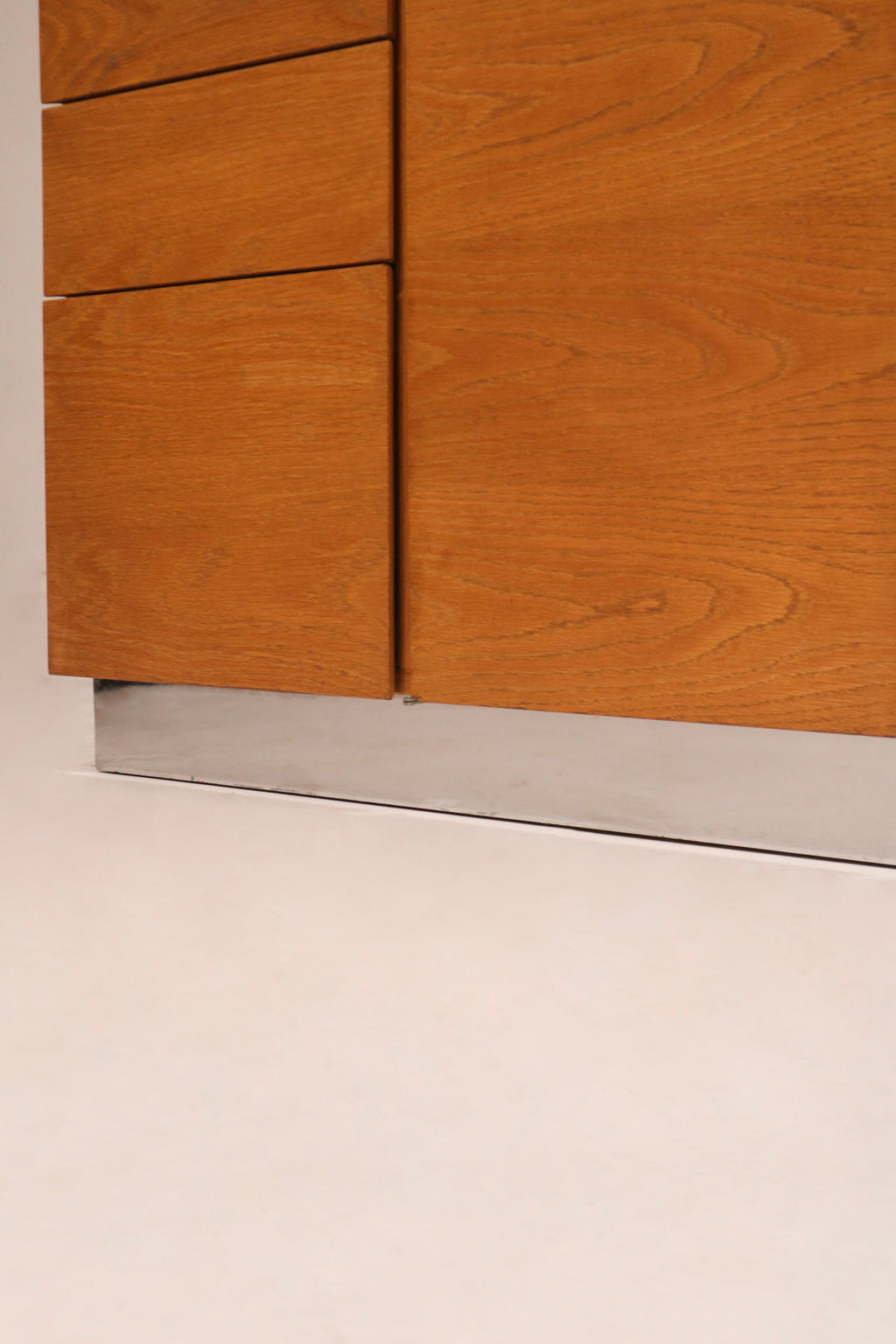 Close-up of the minimalist recessed finger pull handle design