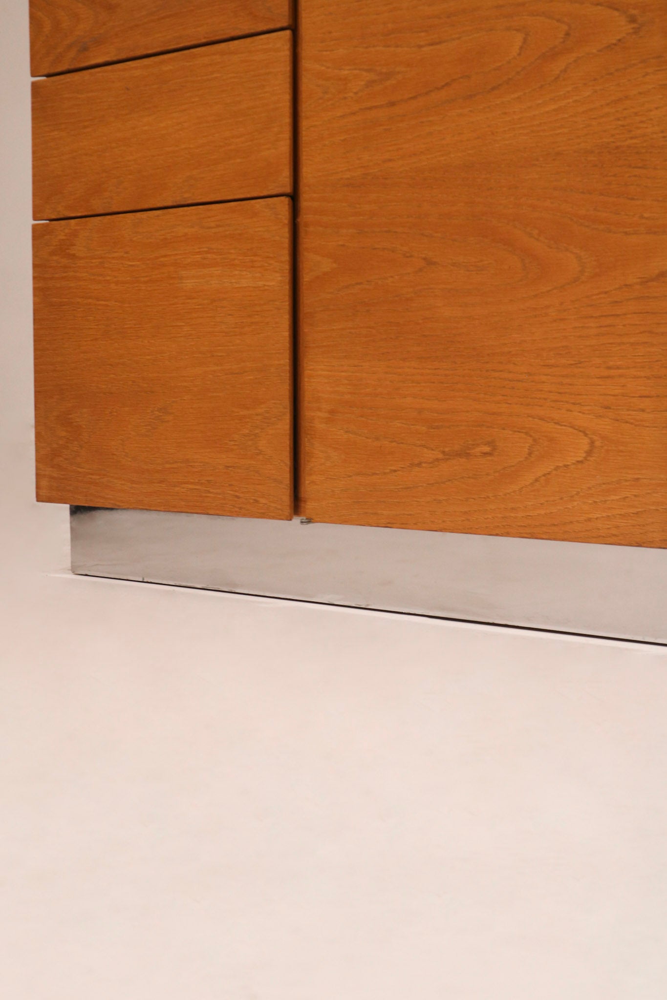 Close-up of the minimalist recessed finger pull handle design