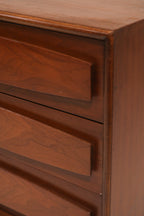 Detail of right side drawers with sculpted fronts and walnut texture