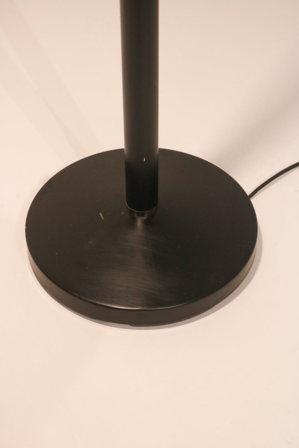 View of the round weighted black metal base for stability