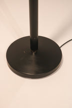 View of the round weighted black metal base for stability
