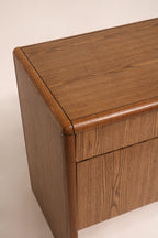 Close-up of rounded oak wood edge corner detail showing solid construction