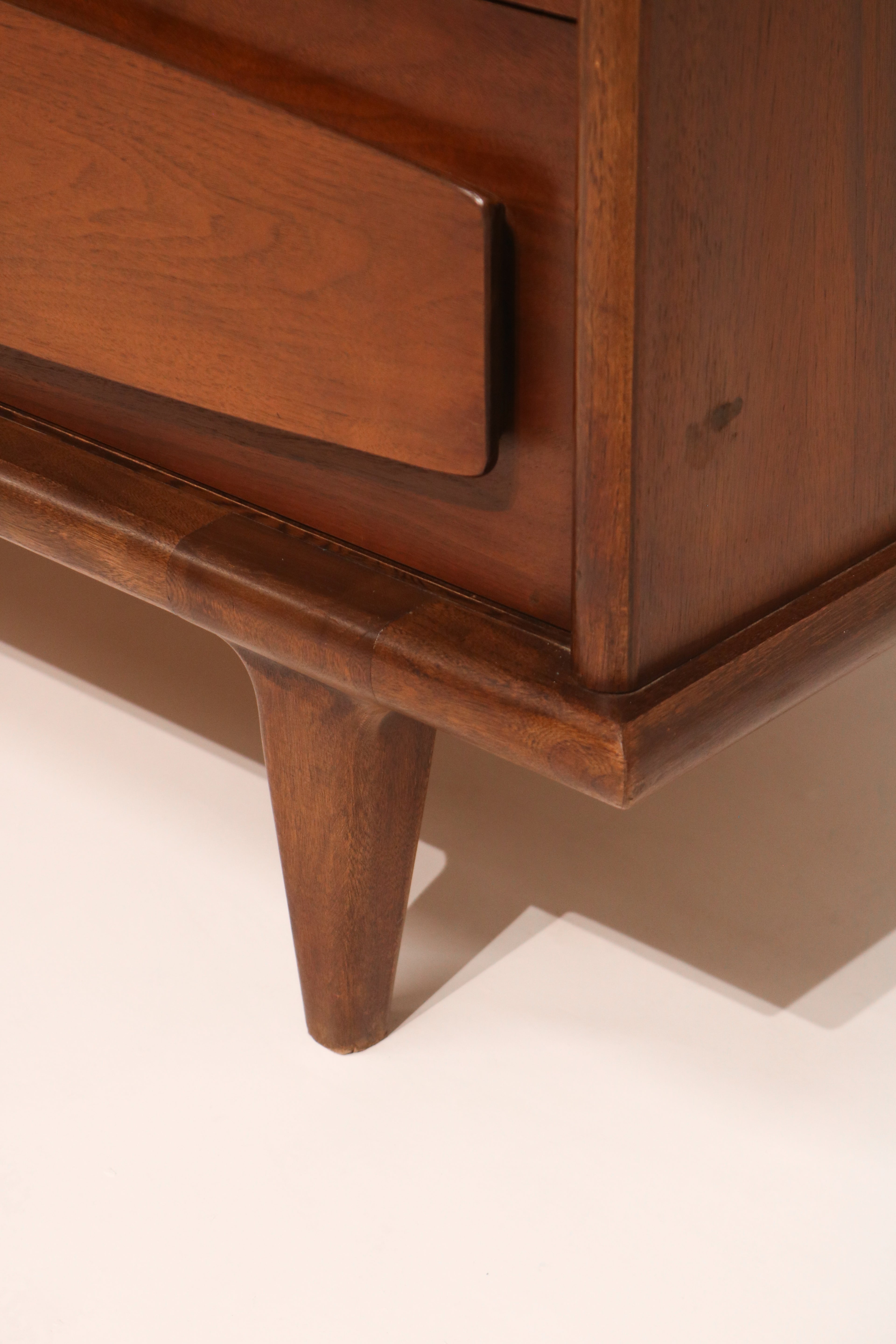 Detail of the signature sculpted drawer front design by American of Martinsville