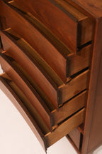 Detail of the sculpted drawer pulls integrated into the curved design