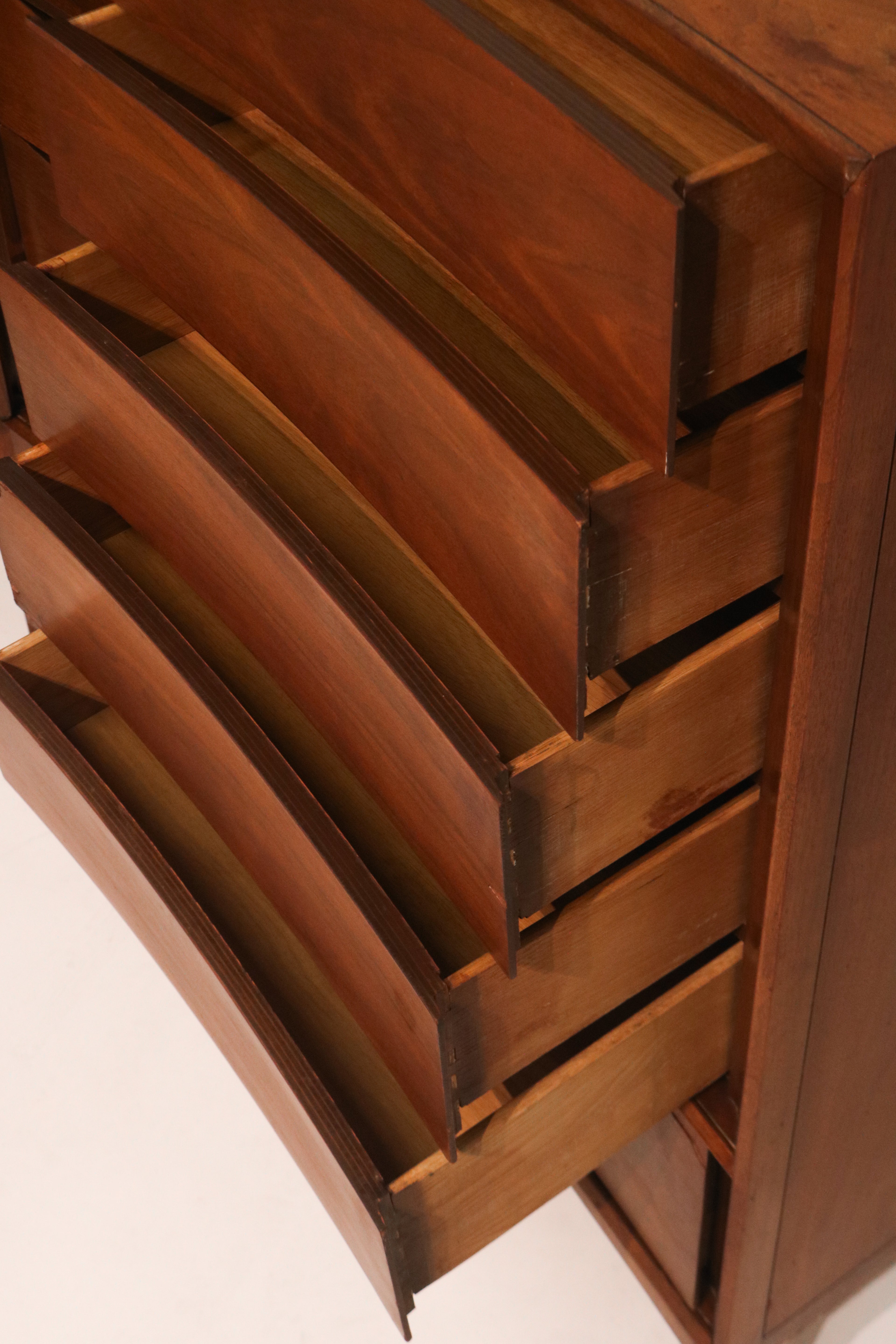 Detail of the sculpted drawer pulls integrated into the curved design