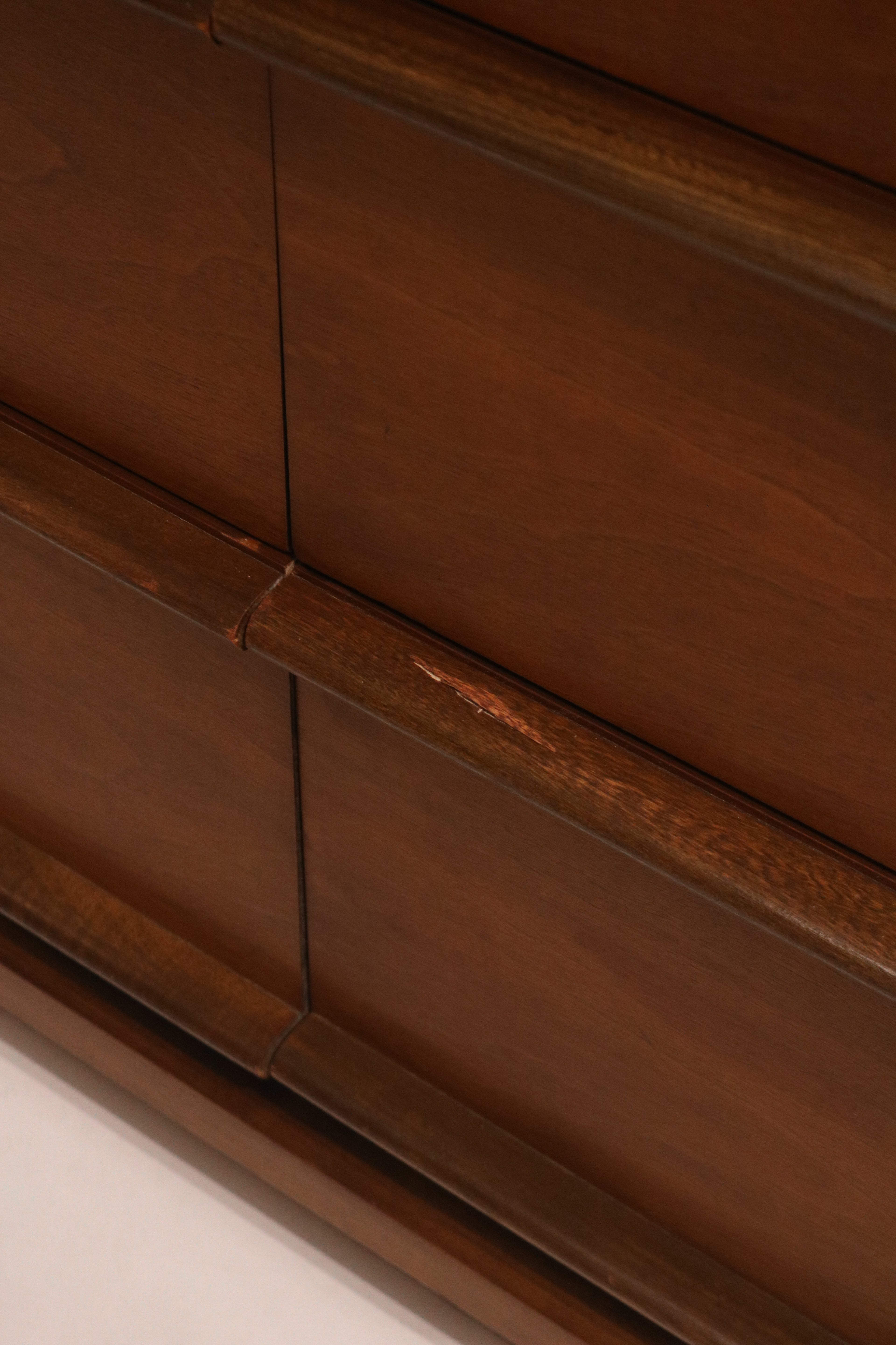 Close-up of the sculpted wood drawer pulls integrated into the design