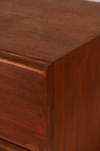 Detail of sculpted wood drawer pulls integrated into the design