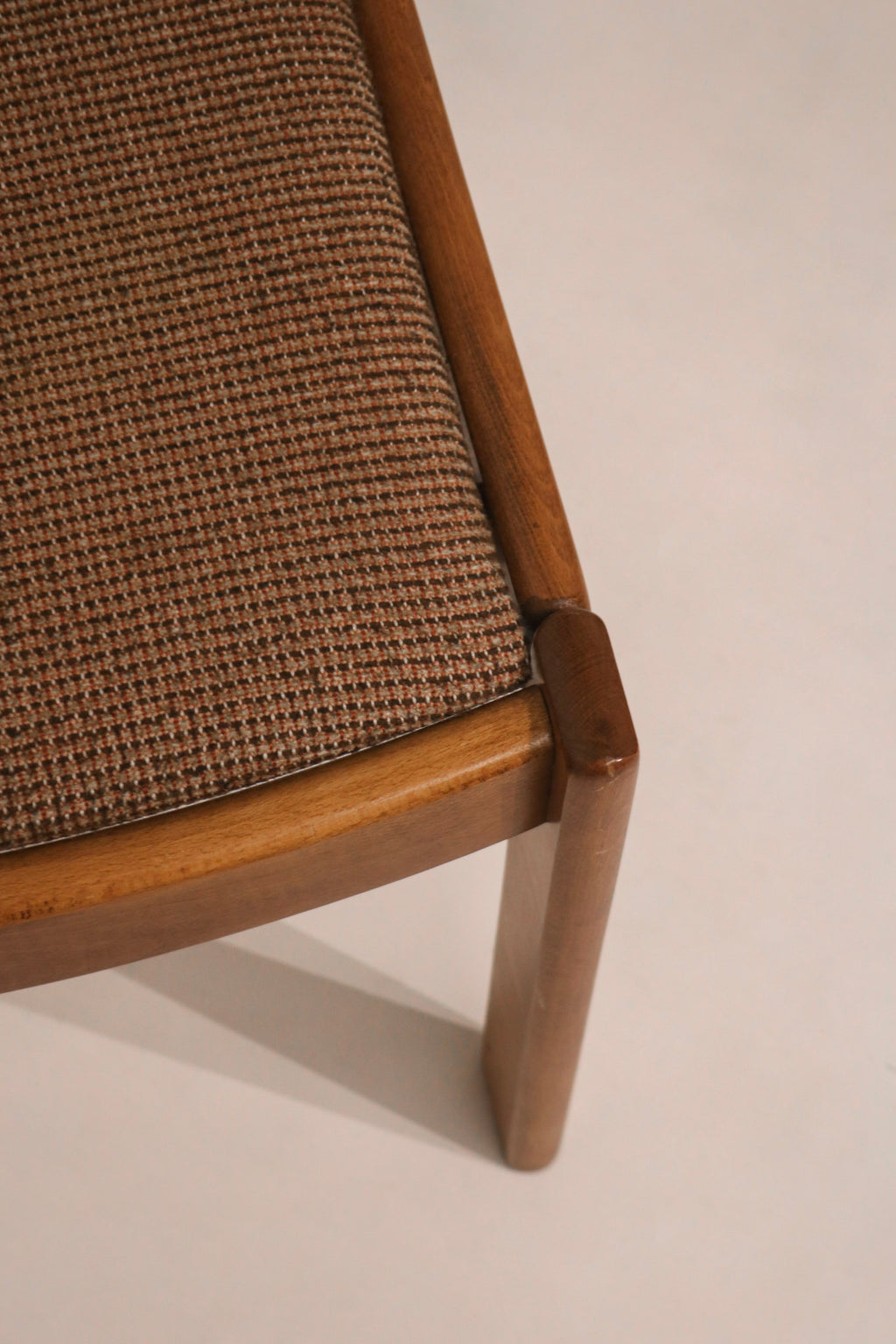 Detail of fabric seat corner connection to solid oak leg