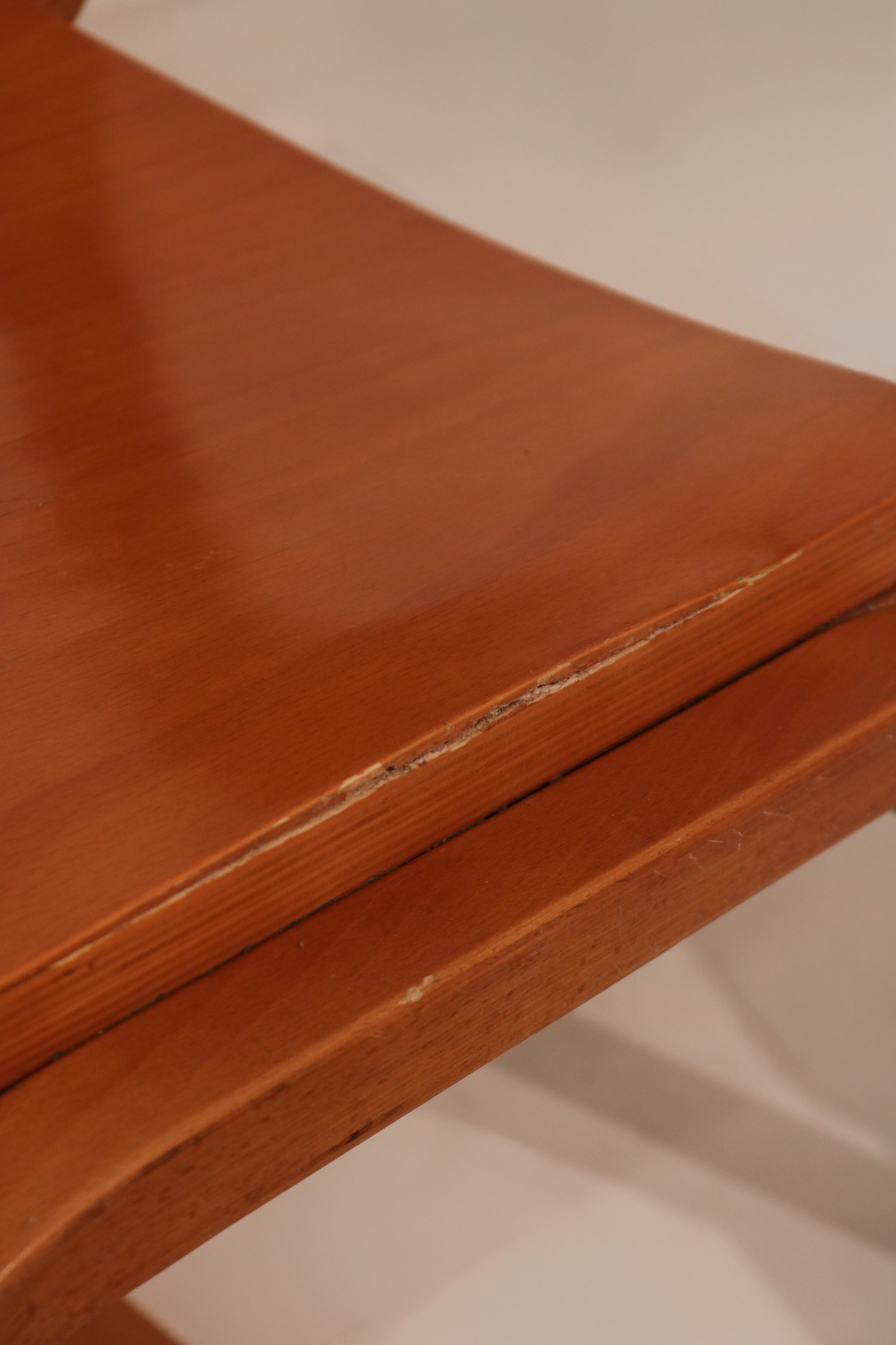 Detail of seat edge showing exposed plywood layers and smooth finish