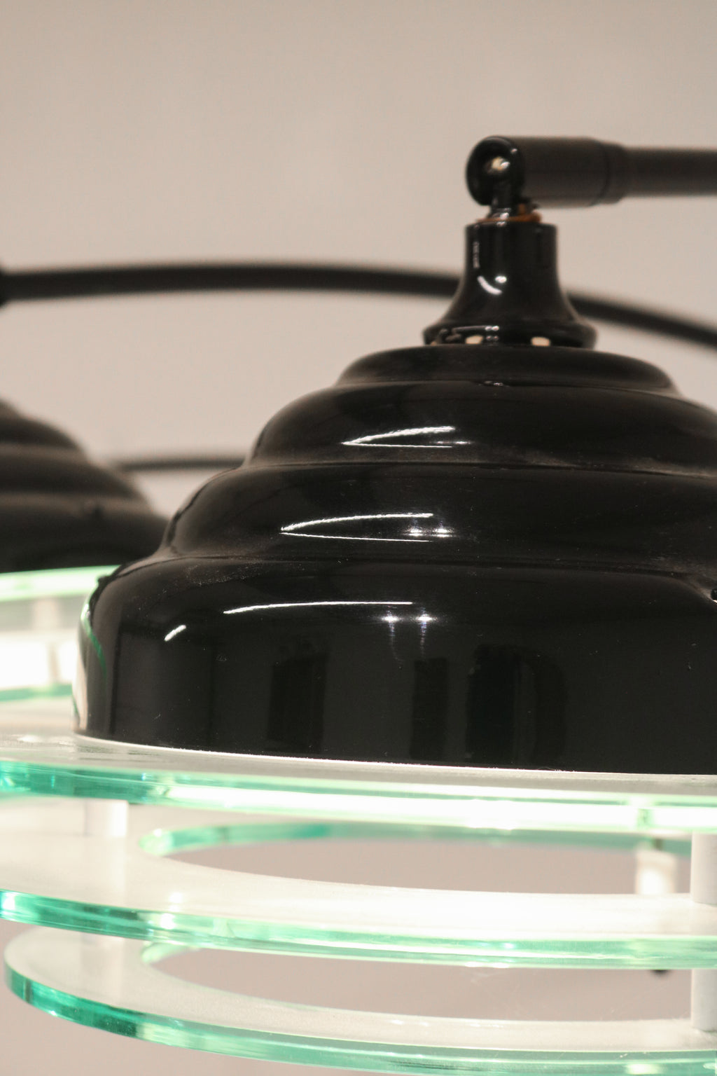 Close-up of the black top cap and finial detail on the acrylic shade