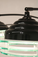 Close-up of the black top cap and finial detail on the acrylic shade