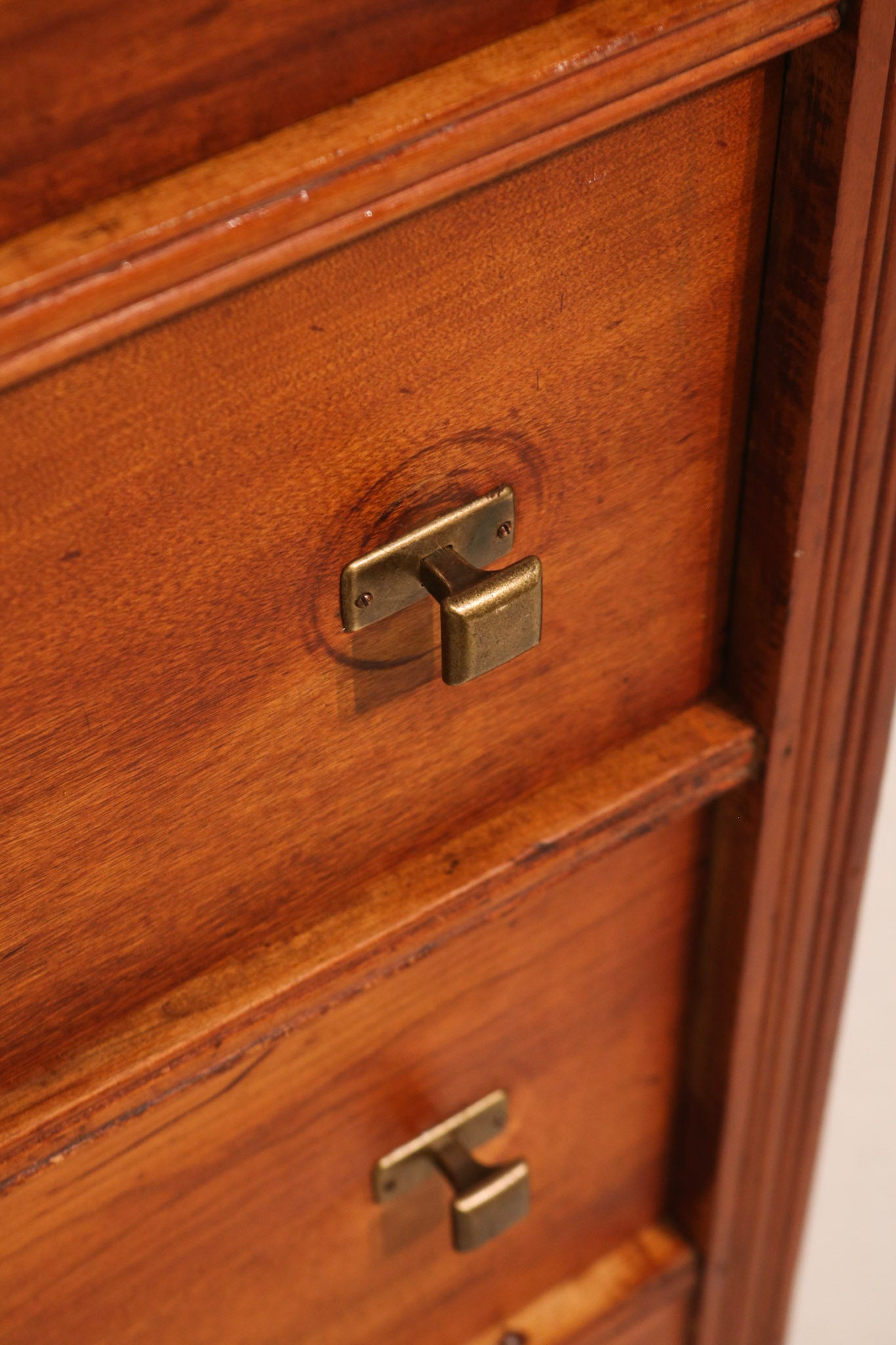 Angled detail view of the side panel wood texture and finish quality