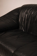 Side armrest profile showing rounded contours and tight stitching genuine leather