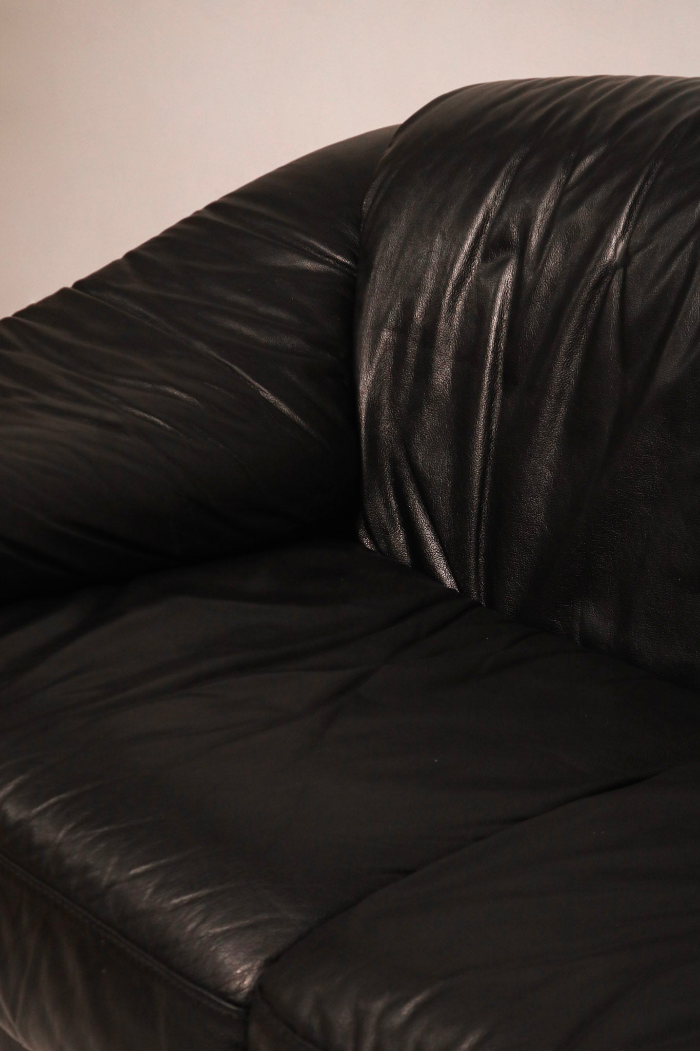 Side armrest profile showing rounded contours and tight stitching genuine leather