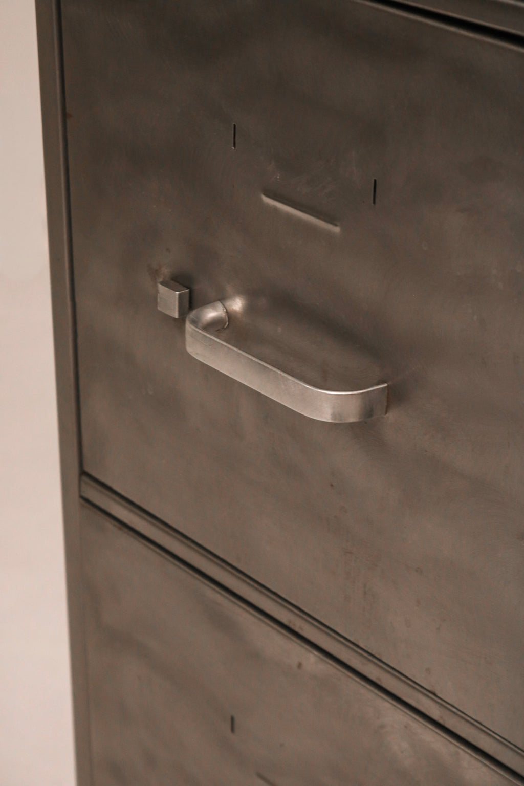 Angled view of side panel highlighting brushed metal texture and finish