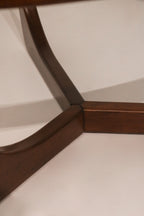 Side profile view highlighting the sculptural shape of the wood legs