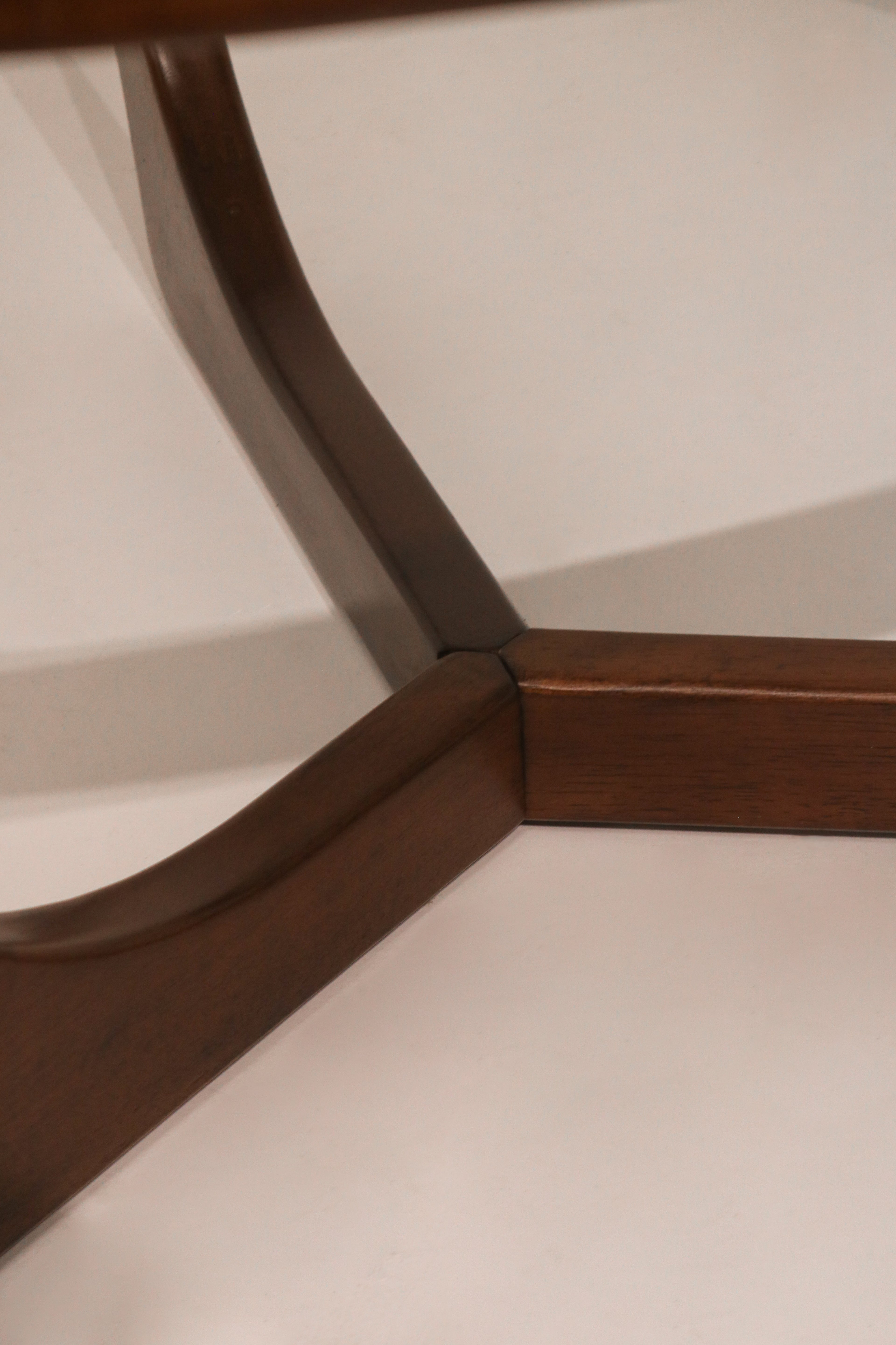 Side profile view highlighting the sculptural shape of the wood legs