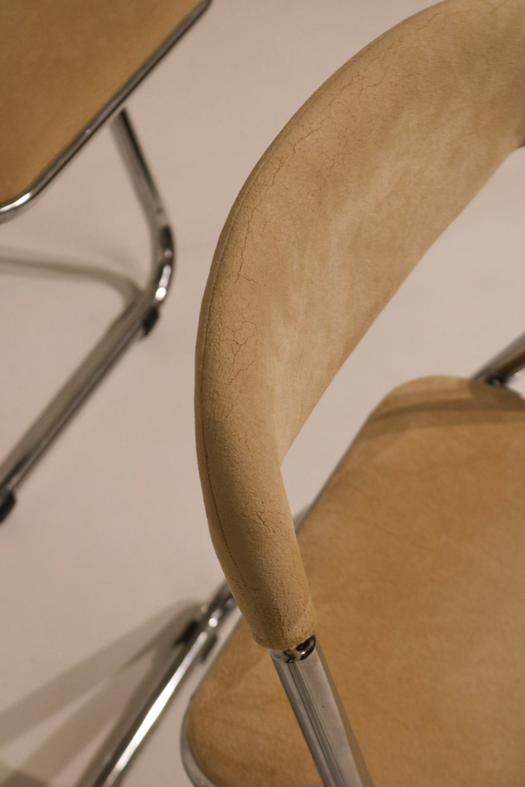 Side view of deployed chair showing geometric chrome frame lines