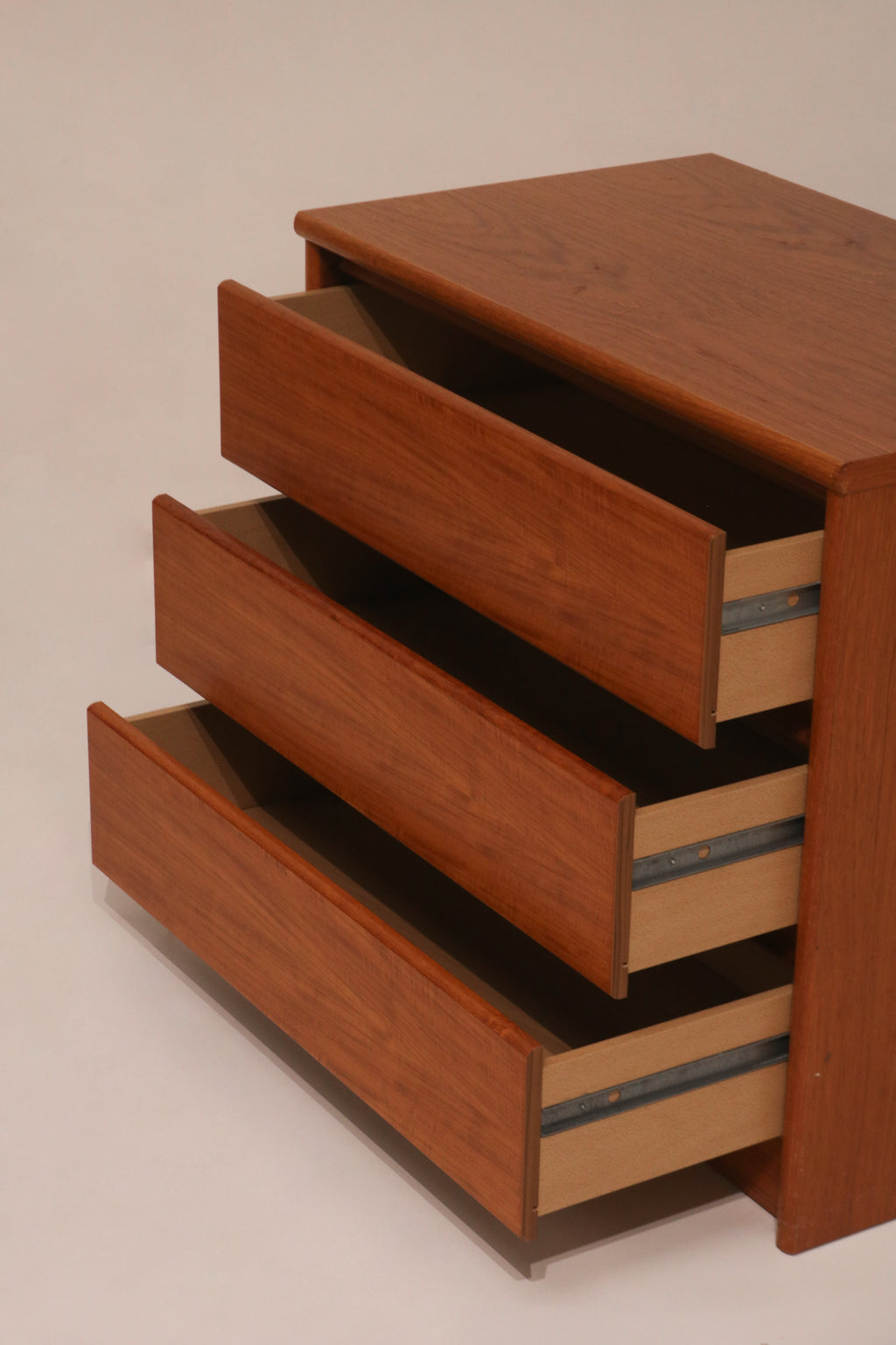 Side view of open drawers revealing particle board interior structure
