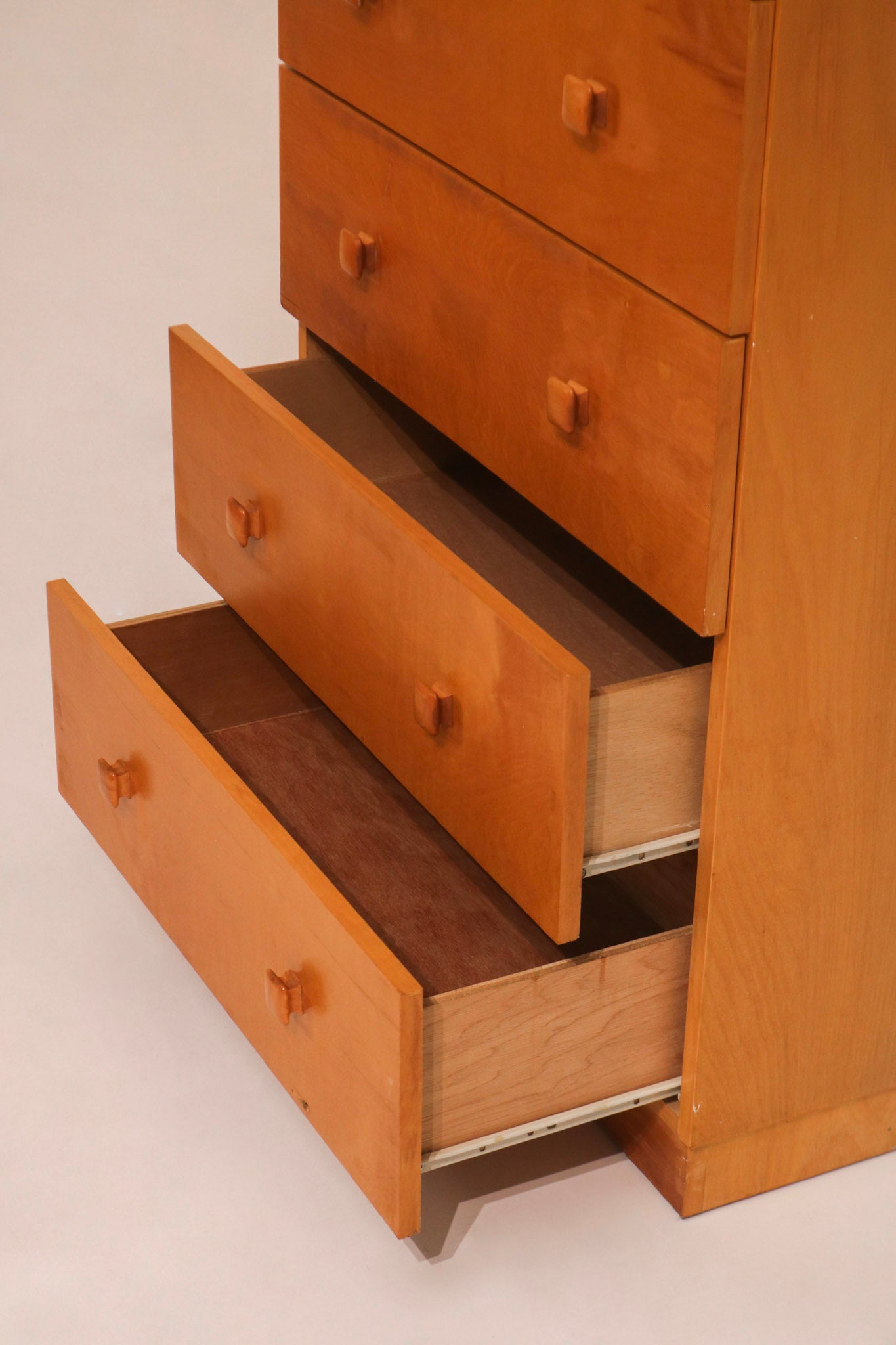 Side view of open drawers revealing clean plywood interior and depth
