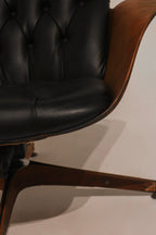 Side view of the ottoman showing tufted cushion profile and base