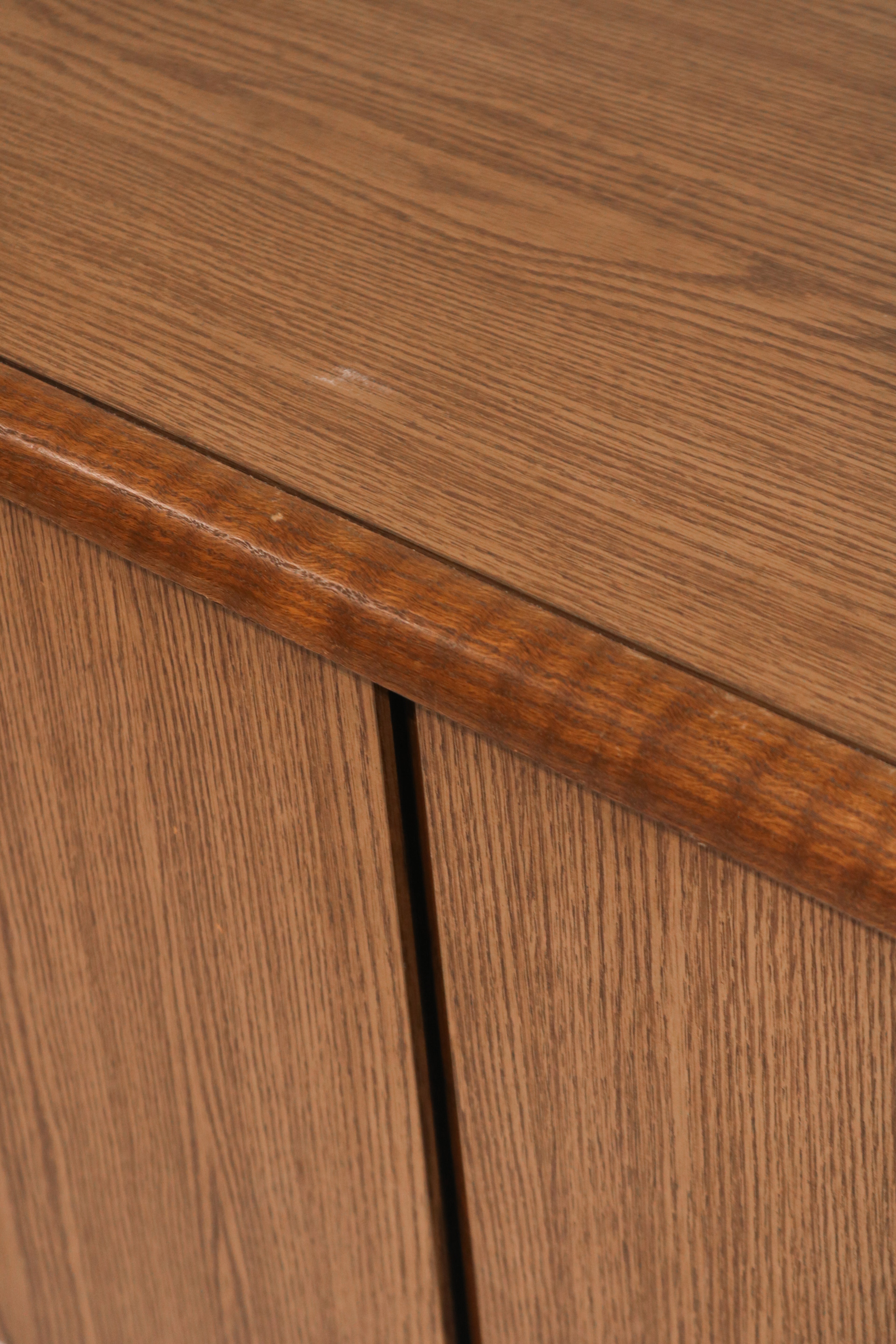 Close-up of solid oak corner joint showing wood finish and wear