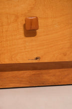 Close-up of the square wooden knob detail characteristic of the design