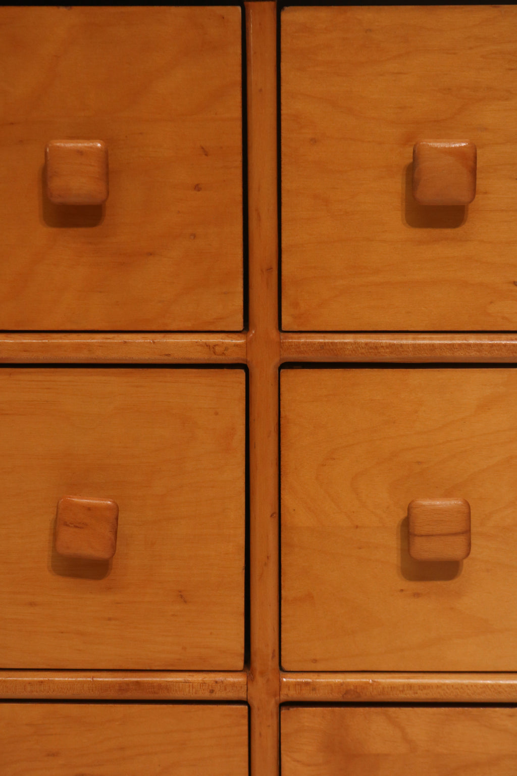 Macro view of the square wooden knobs arranged in a grid pattern
