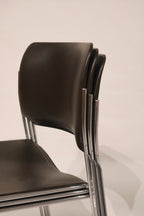View of chairs stacked together demonstrating space-saving functionality