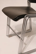 Close-up detail showing how the chair frames align when stacked