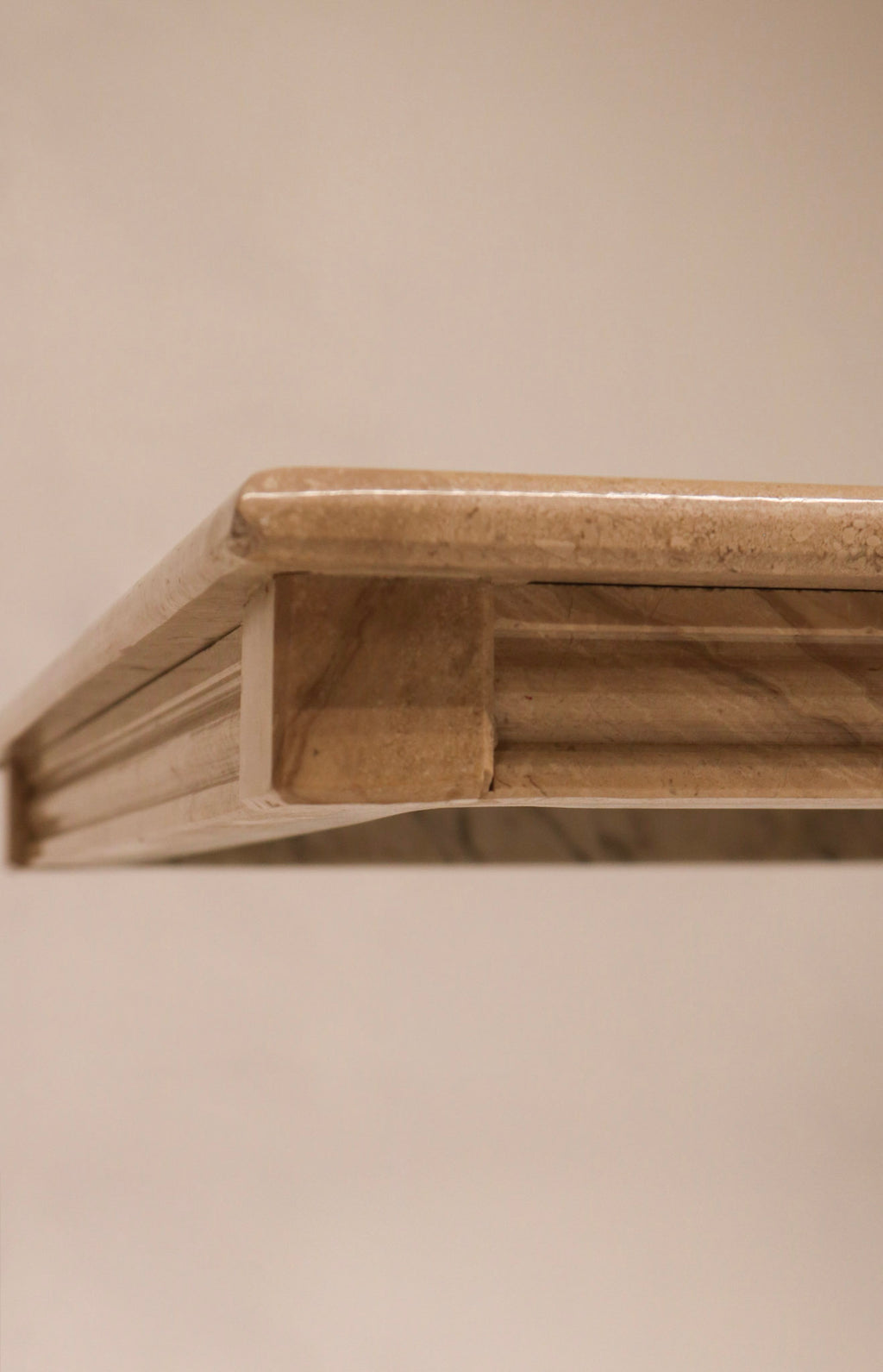 Close-up of the stepped or waterfall edge profile design on the marble top