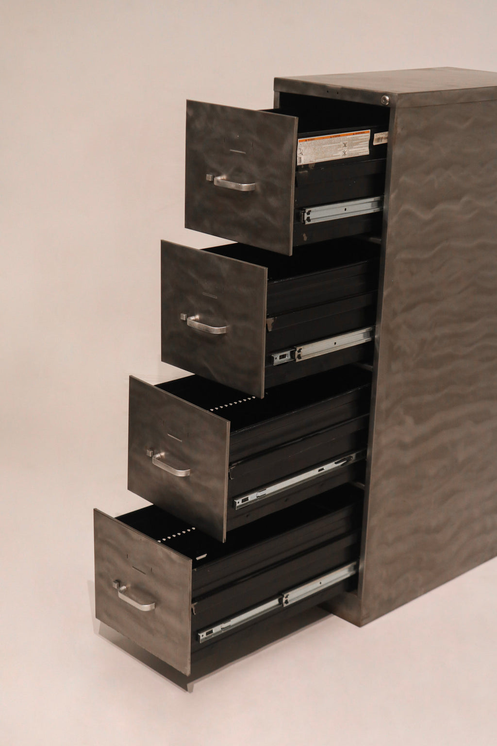 Side profile view of stepped open drawers demonstrating full extension