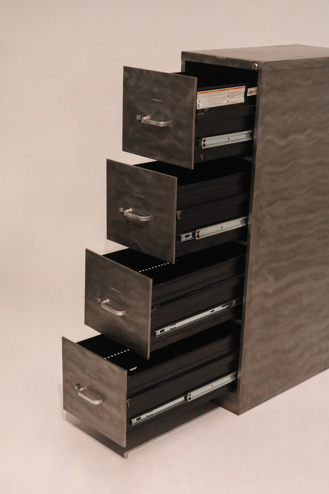 Side profile view of stepped open drawers demonstrating full extension