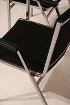 Detail of stitching on black fabric upholstery at armrest connection