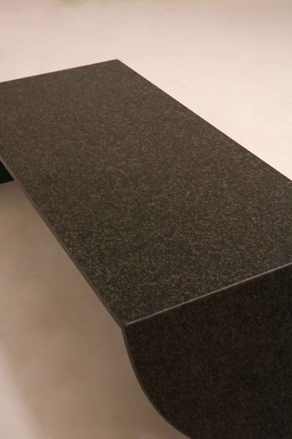 Angled top perspective showing surface sheen and black stone material quality